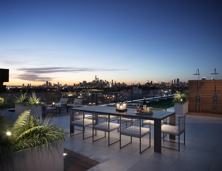 Landscaped Roof Terrace with Sweeping Skyline Views Featuring a Sundeck, Outdoor Showers, Lounge Area, and Dining Area with BBQ Grills.