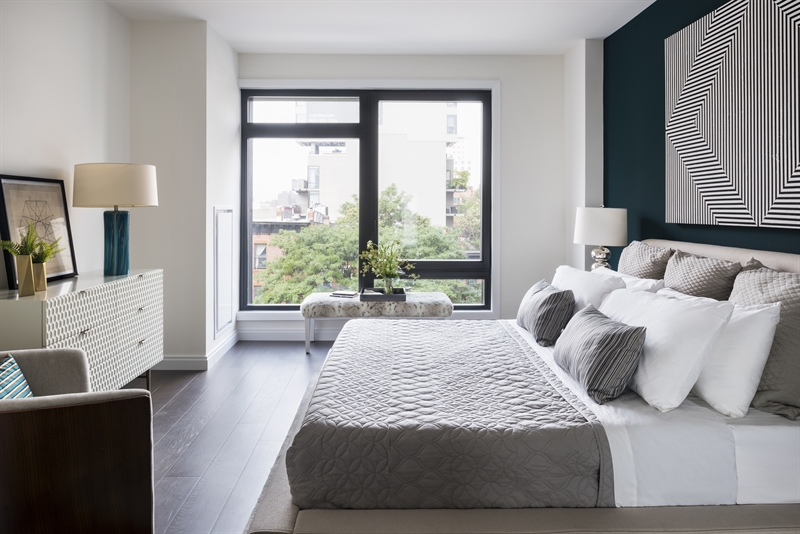 Custom oak flooring in a tranquil dark smoky stain and ceilings that reach 10 feet in height with striking floor-to-ceiling windows provide expansive views of Brooklyn and help you ease in and out of your day.